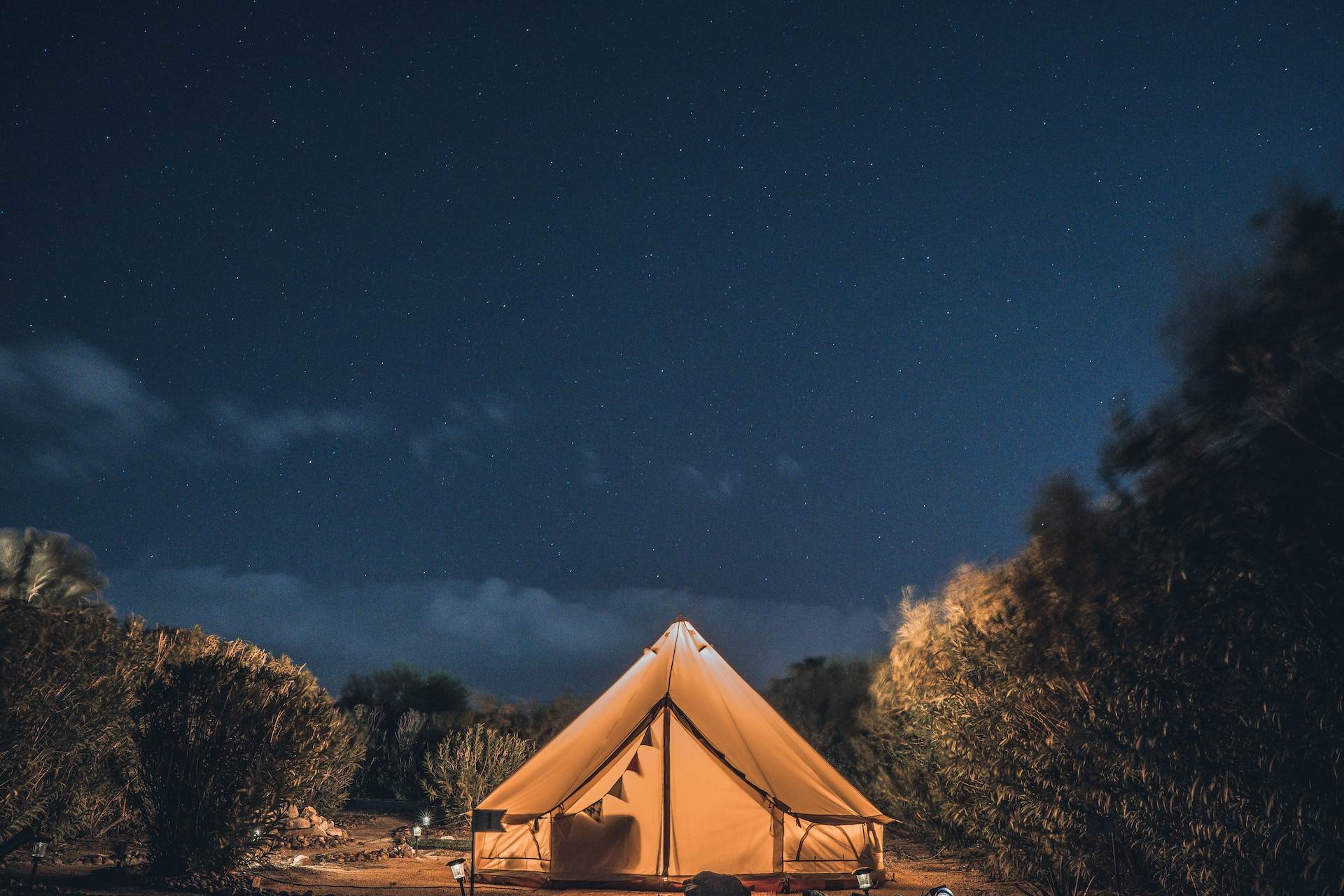 Camping tent beside a beach during the night time.