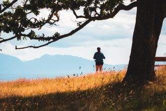 A woman standing beside a waterbody in the Hornby Island.
