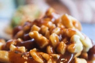 A bowl of poutine - Canadian snacks.