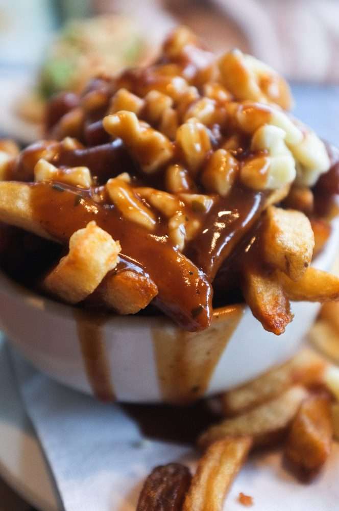 A bowl of poutine - Canadian snacks.