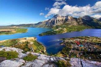 A scenic view of Waterton National Park. A beautiful nature view of mountains, lakes and greenery is seen.