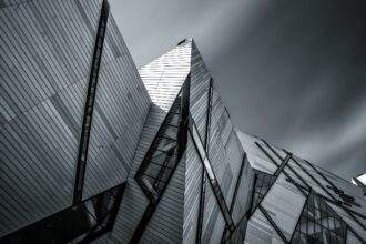 A black and white picture of a roof of a building. Fever is giving the highlights of the Royal Ontario Museum.