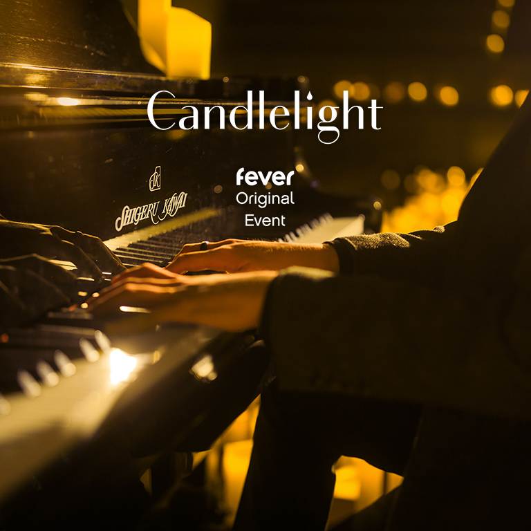 A close-up of a piano played by a person during a performance for Candlelight's Tribute to Jay Chou event.