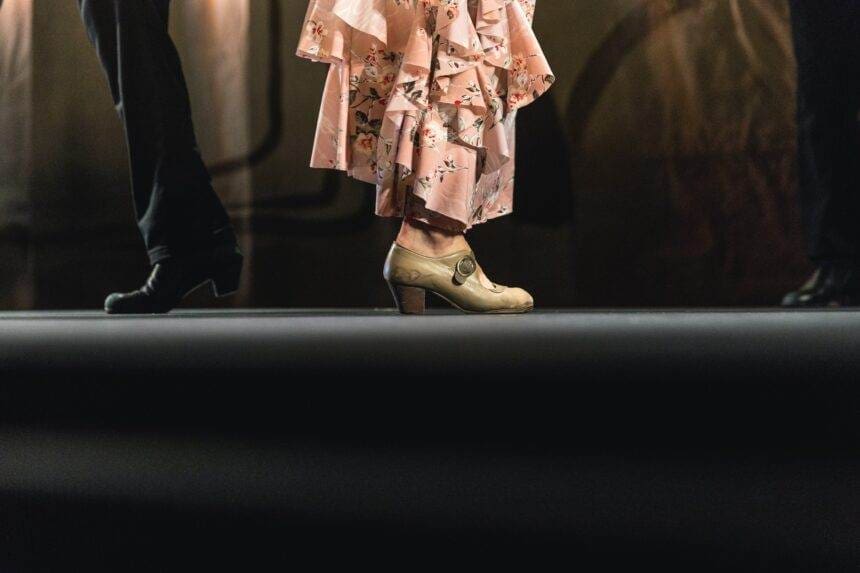 A close-up of the feet of Flamenco dancers while dancing on the stage.