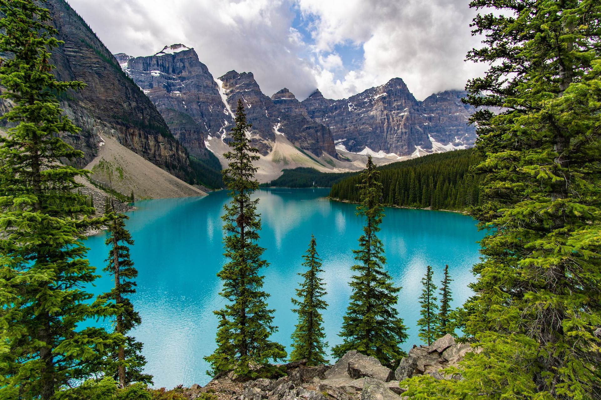 A view of Moraine Lake with mountains and trees alongside.