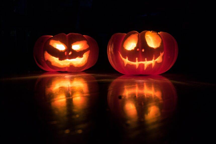 Two spooky carved pumpkins in the dark give a Halloween Resurrection vibe.