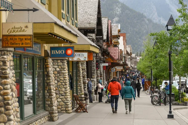People walking on the street in Downtown Banff.