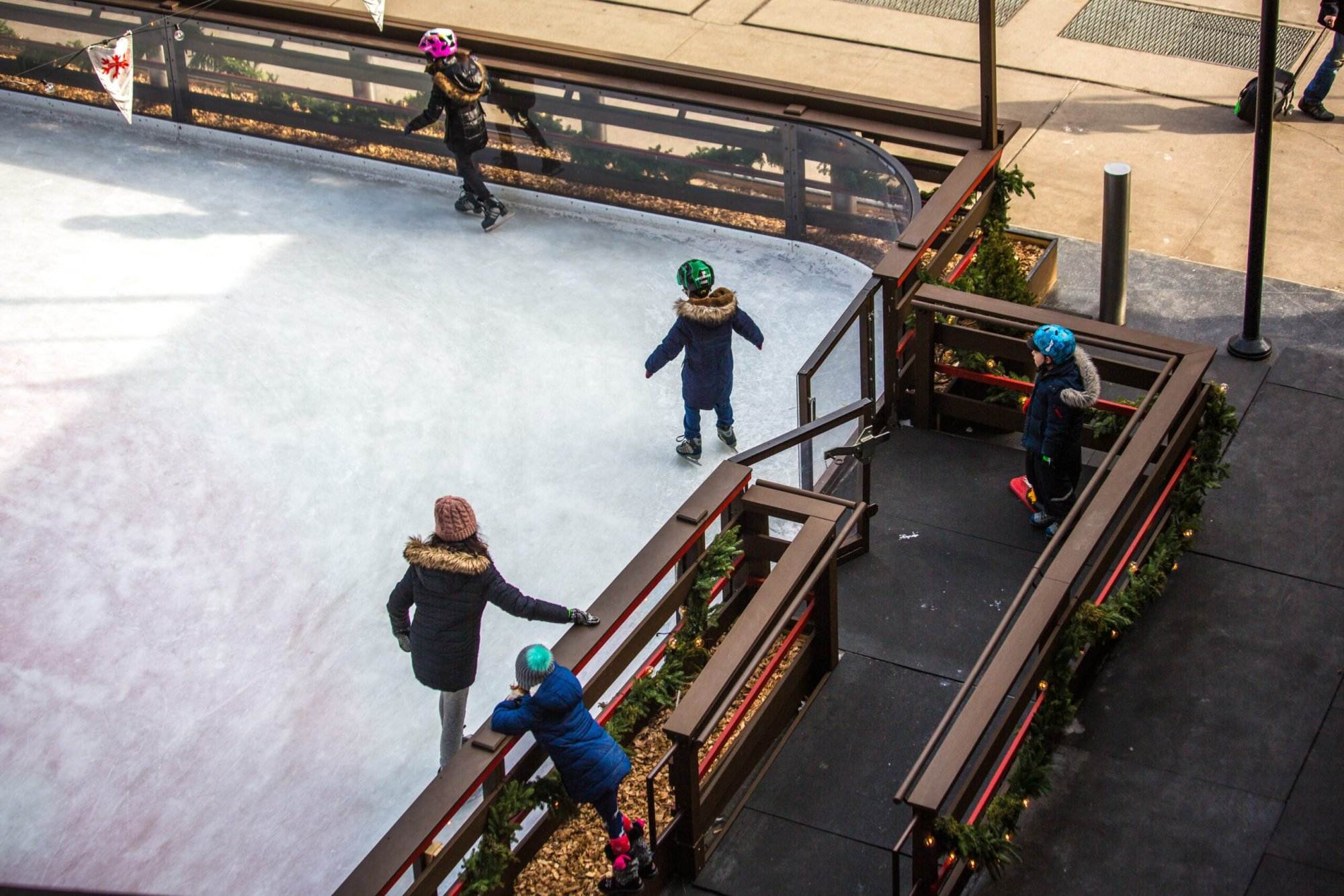 Kids skating on the Ice rink during winter.