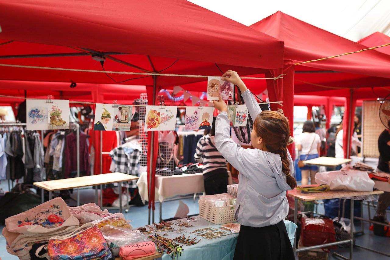A woman vendor setting up her shop in one of the flea markets in Vancouver.