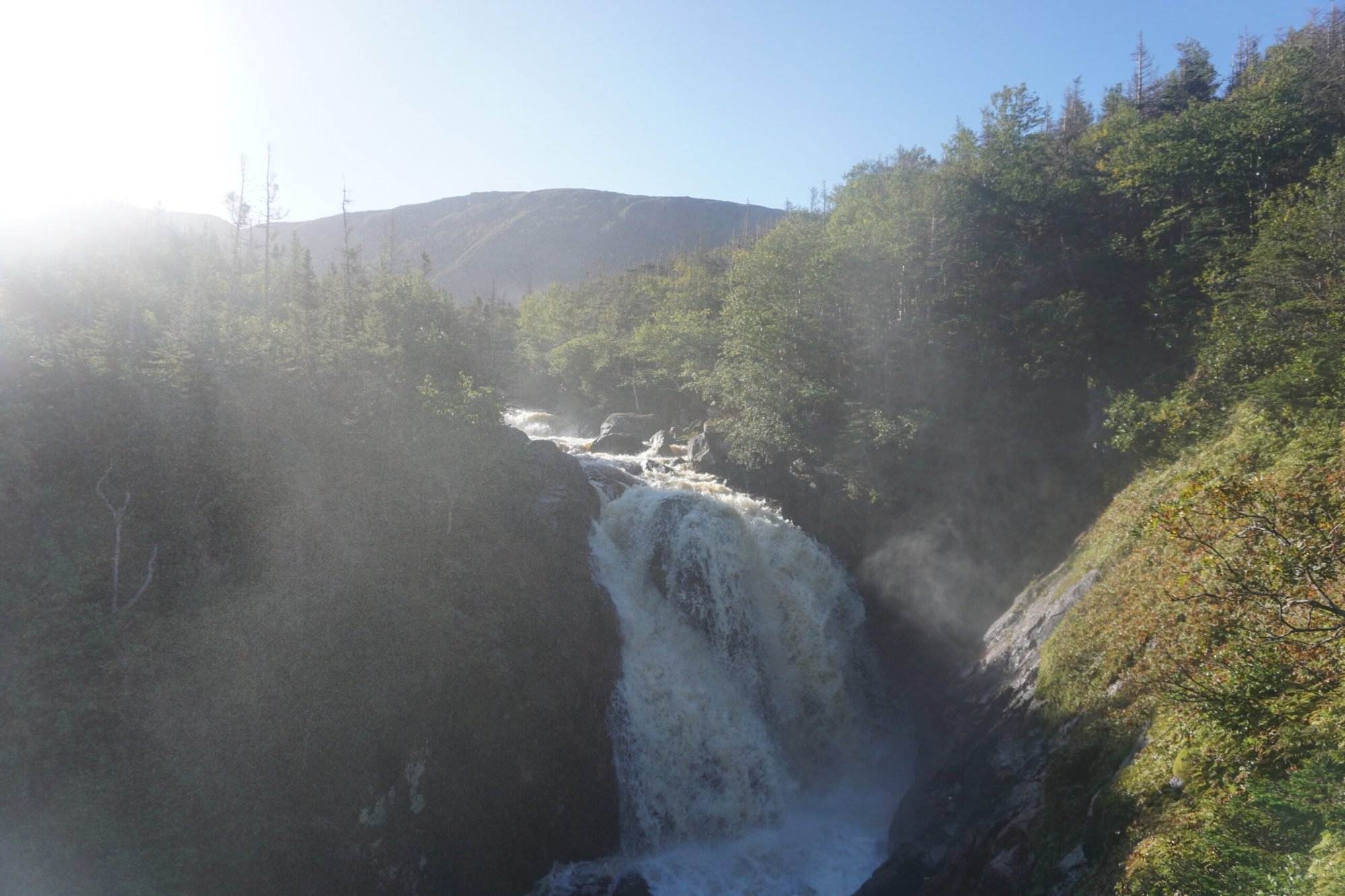 A view of amazing mountains in Canada with foggy scenery of waterfall in the middle of the many Gros Morne Mountains