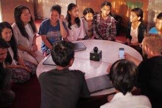 A community sitting at a big table to communicate.