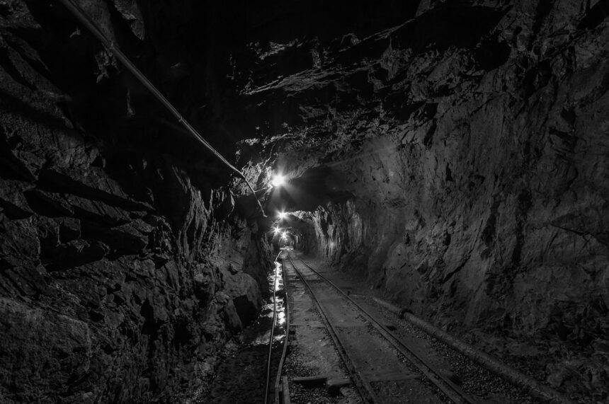 A dark shallow path of an underground tunnel for mining experience.