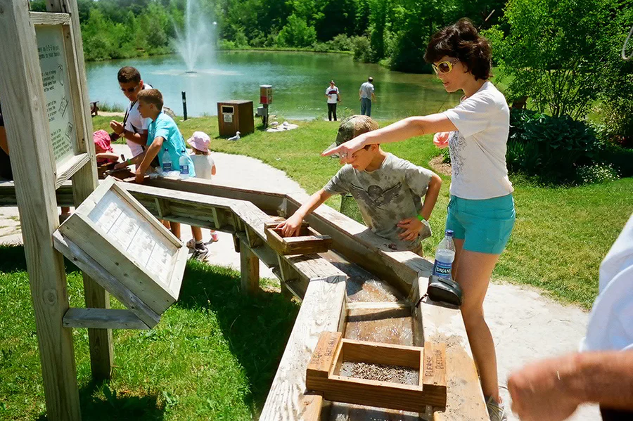 People near a waterbody in the Blue Mountains Scenic Caves