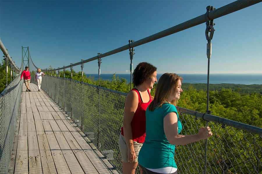 People walk and enjoy the views from a bridge in the Blue Mountains Scenic Caves.