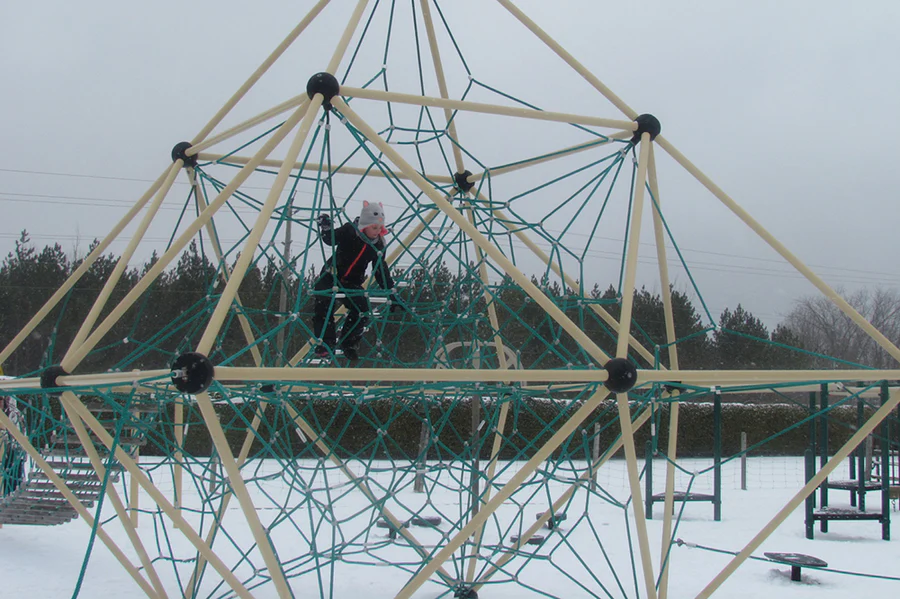 A boy climbing on rope swing in the Blue Mountains Scenic Caves