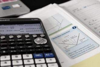 A view of mathematics study with a calculator on a maths book.