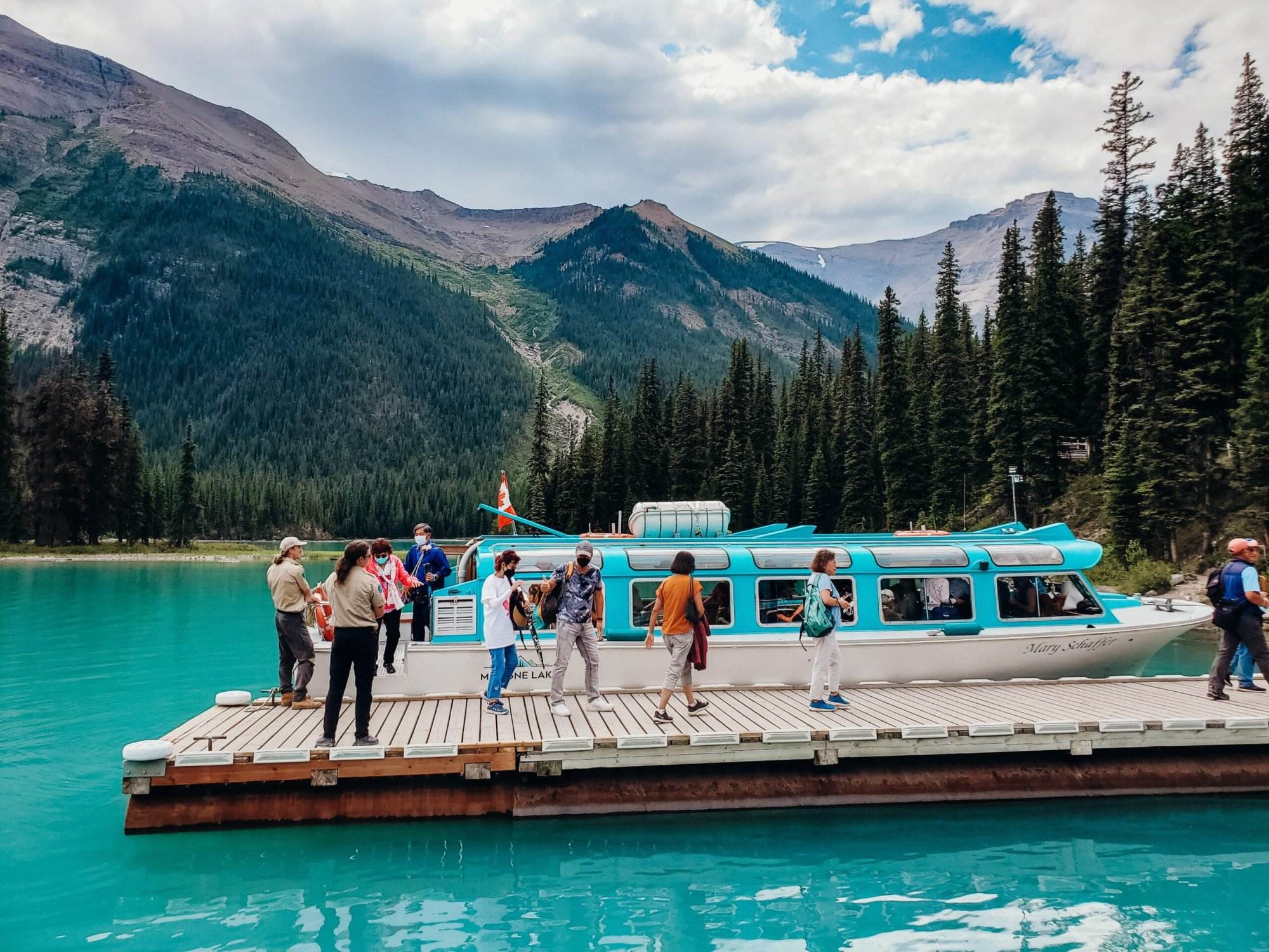 A people enjoying on a boat in Maligne Lake.