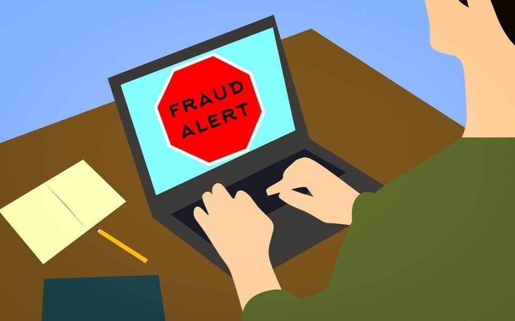 A vector art of fraud alert on a laptop screen.