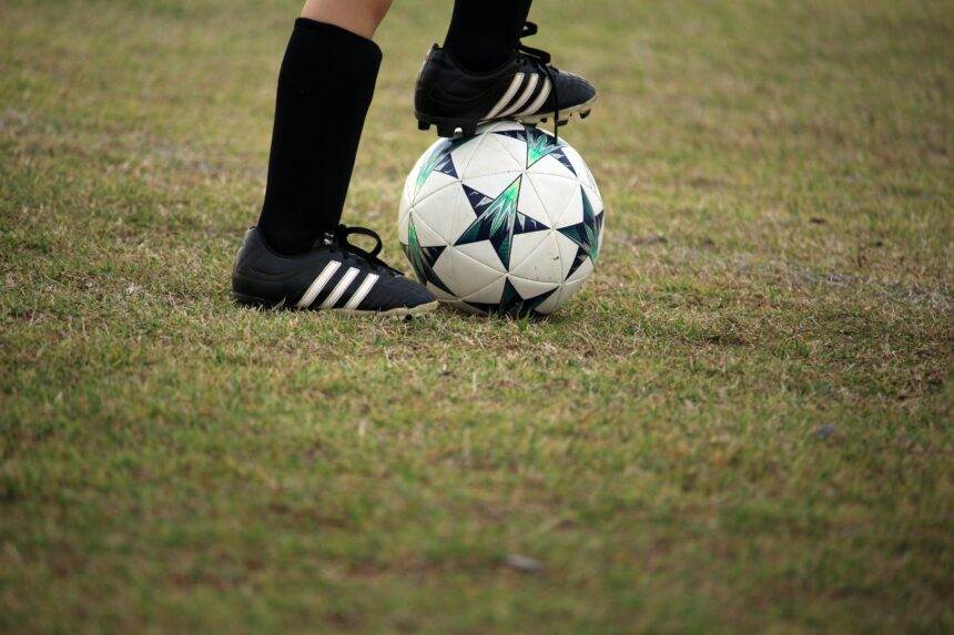 Person playing Soccer in field