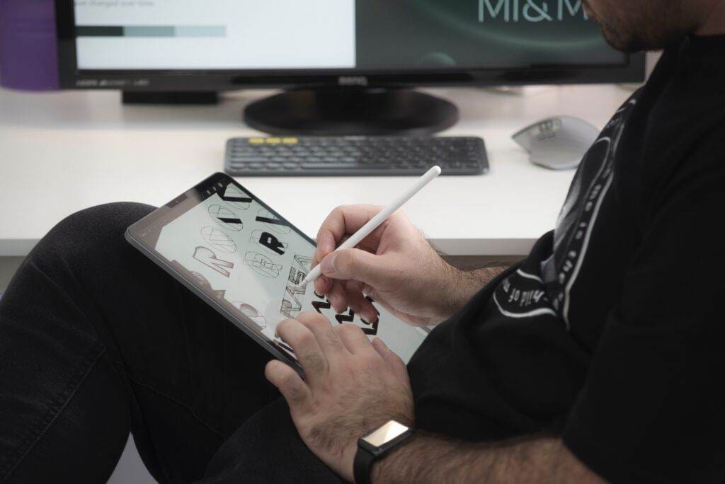 A person designing something on a tablet.