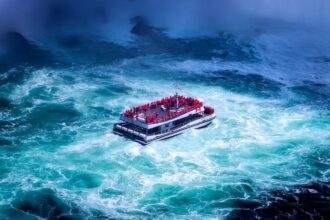 A boat in the middle of a waterbody of Niagara Falls.
