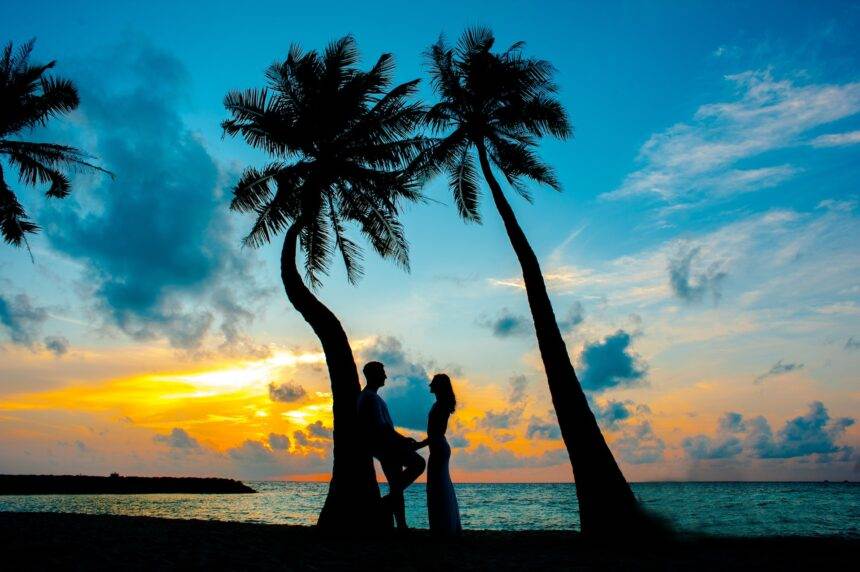 A silhouette of a couple on a beach.