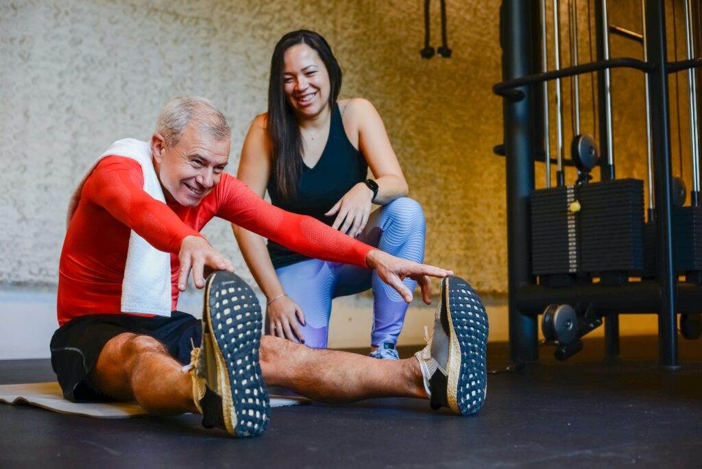 A woman training an old man 