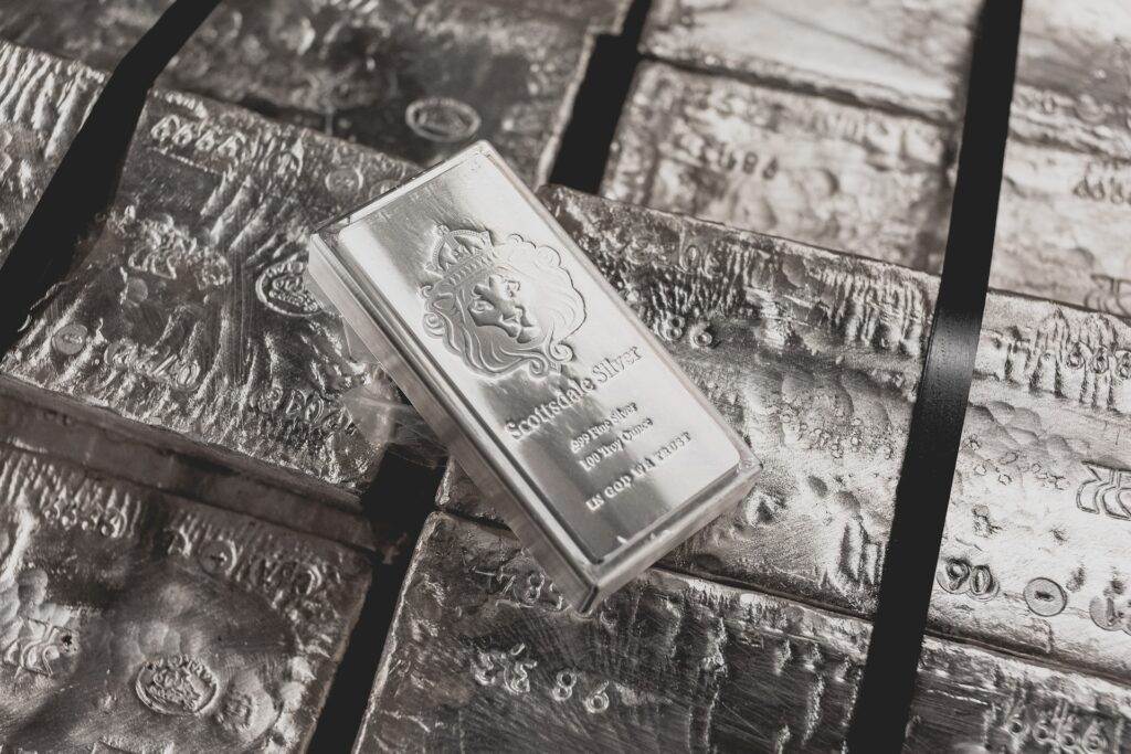 A silver bar is kept on top of a stack of bars.