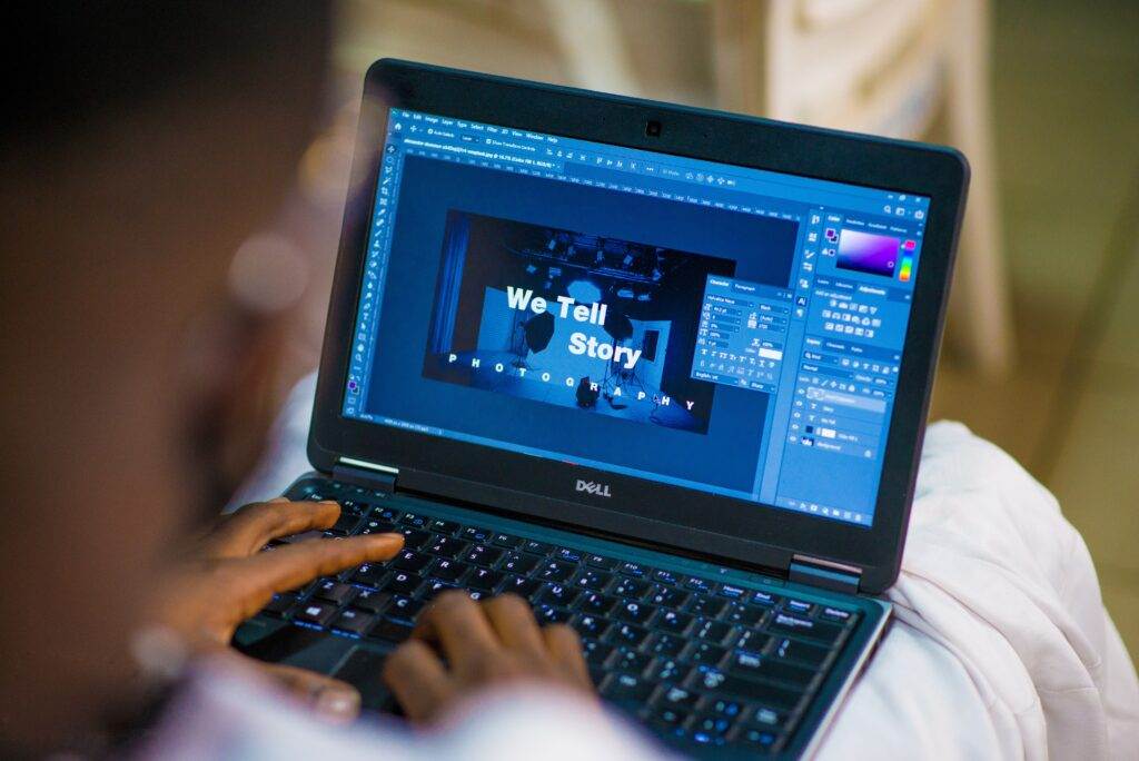 A person using a laptop for graphic design.