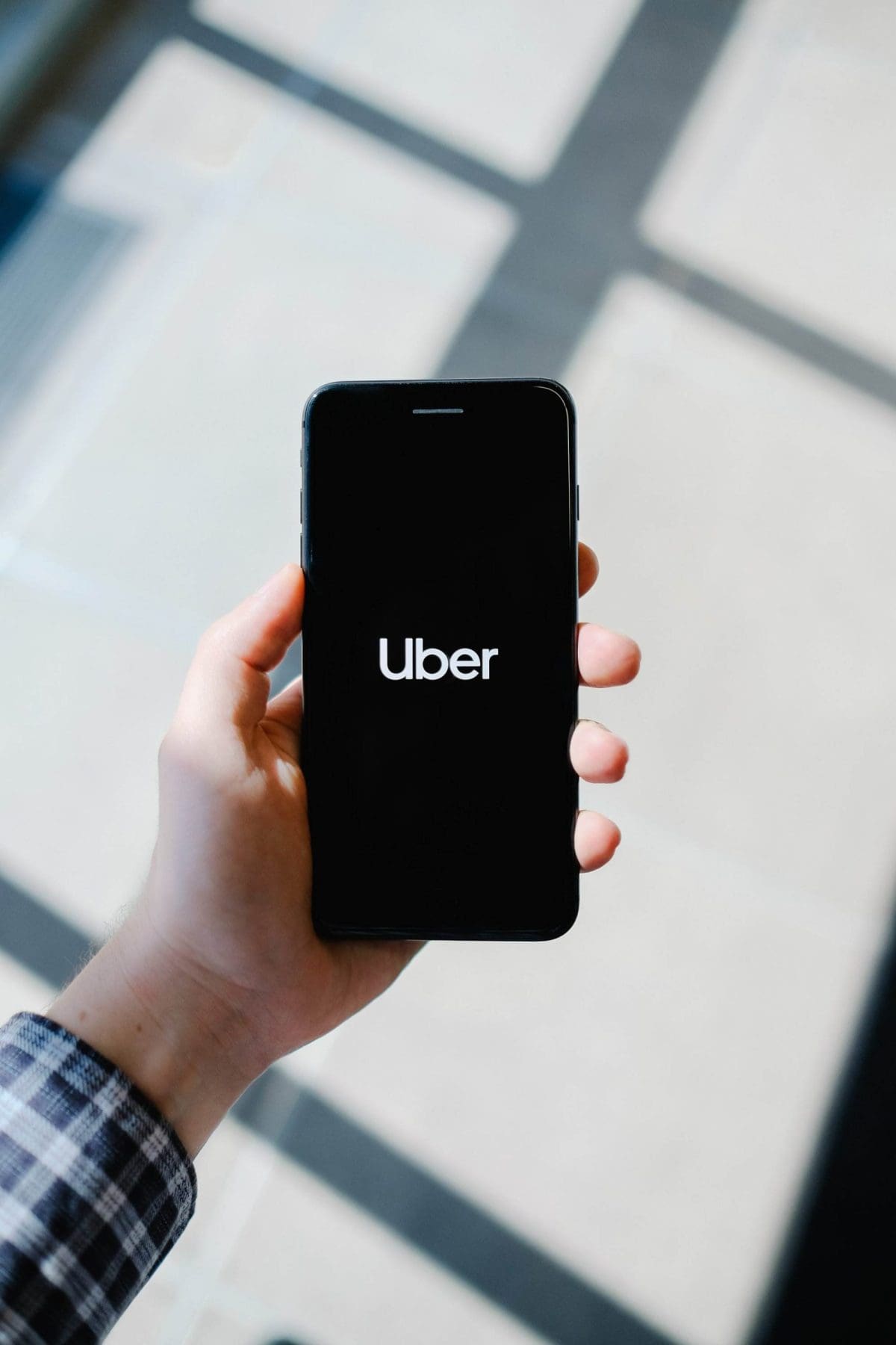 The uber logo on the mobile screen.