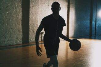 A man playing basketball game