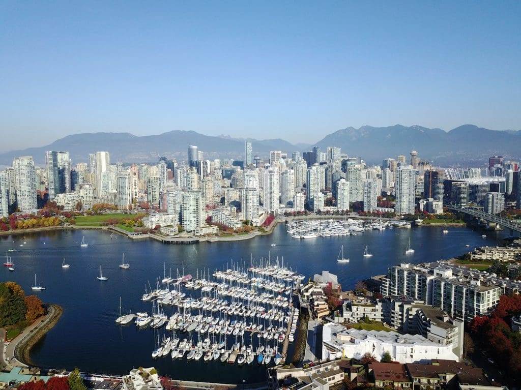 A drone view of a seaport in Vancouver with the high-rise buildings in the background.