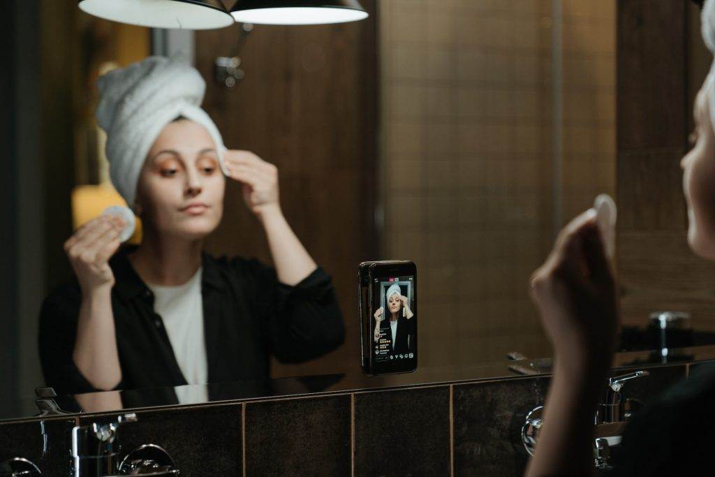 A woman shooting her skincare routine for video ads