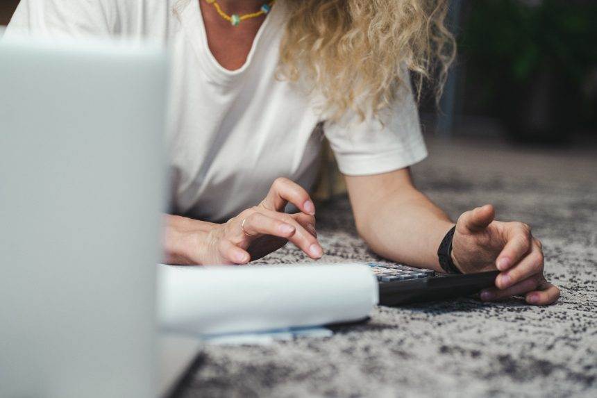 A woman working using a calculator.