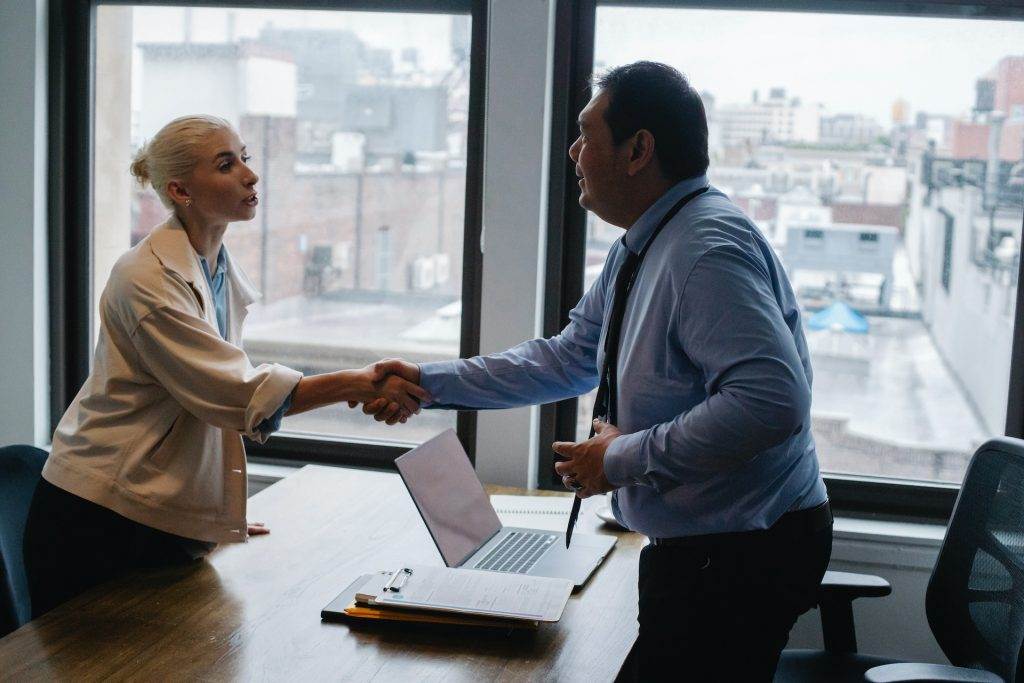 People shaking hands after screening interview test