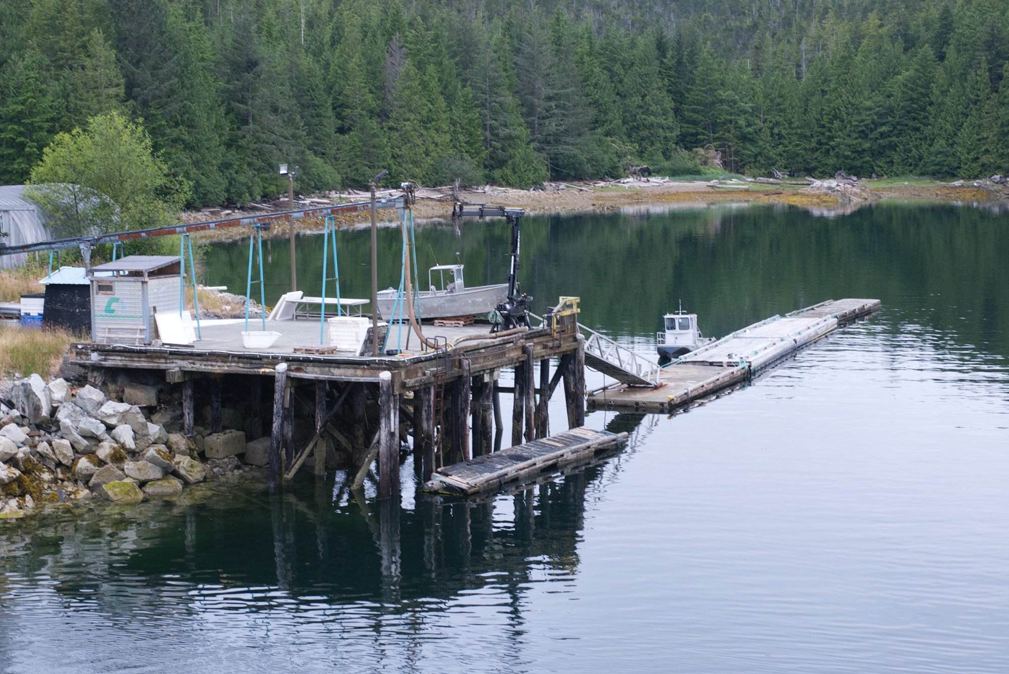 dock on a lake with a boat in the water