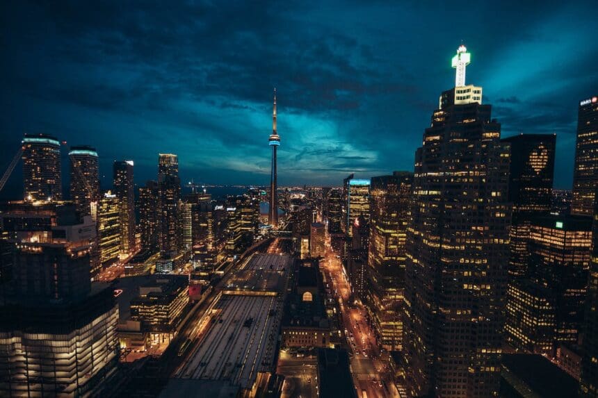 Nighttime skyline of Toronto with illuminated CN Tower.