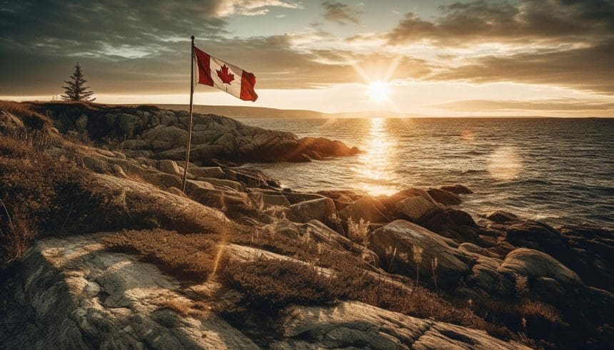 Canadian flag over coastal rocks at sunset